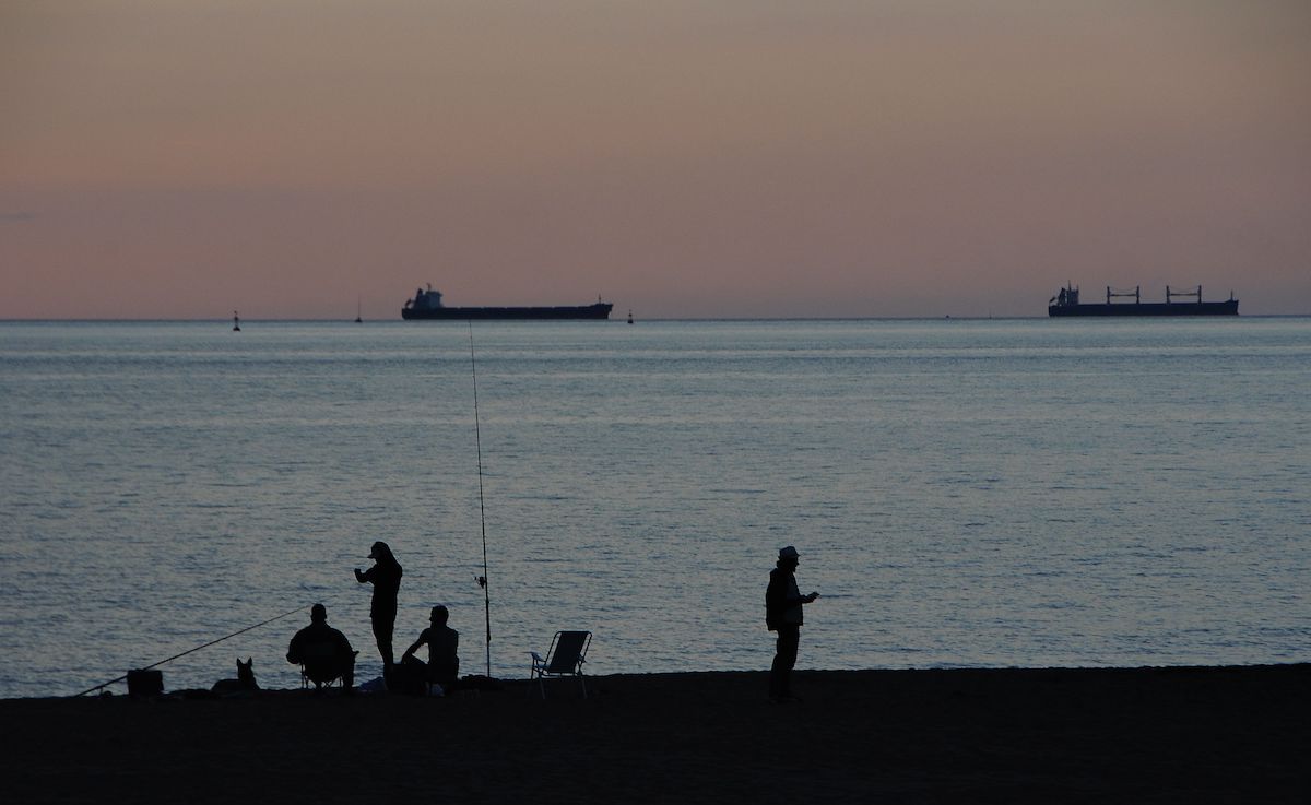 Ships and people fishing in Ereaga Beach Ships and people fishing in Ereaga Beach